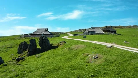 Small Mountain Huts on Top of the Hill with natural Ancient Stones Next to Road. Stock Footage 144174788