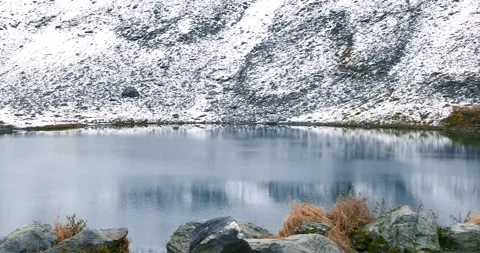 Small mountain lake at Hatcher pass in Alaska during late autumn time with .. Stock Footage 320448338