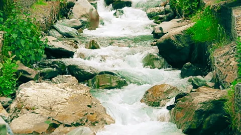 Small mountain river with artificial rapids made of cobblestones Stock Footage 65528941