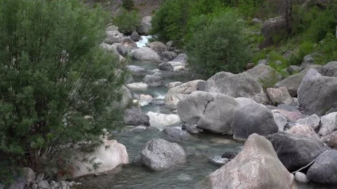 Small mountain river with crystal clear water. Water flows over the stones Stock Footage 157057630