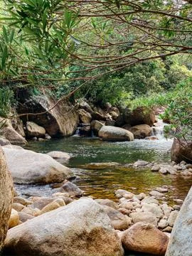 Small mountain river flows among large stones in mountainous areas through th Stock Photos