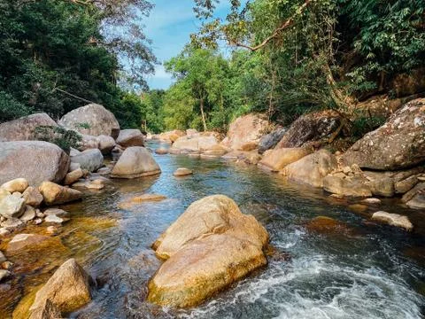 Small mountain river flows among large stones in mountainous areas through th Stock Photos