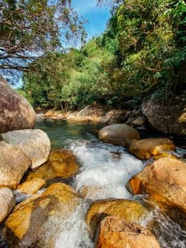 Small mountain river flows among large stones in mountainous areas,  forest Stock Photos