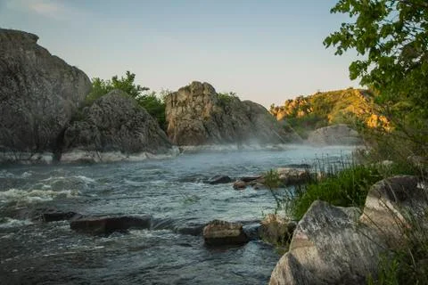 Small mountain river. Landscape with stream flowing between rocks. Water in Stock Photos