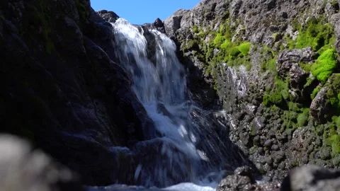 Small mountain river waterfall with crystal clear water. Footage. Water flows Stockbeeldmateriaal 258094498