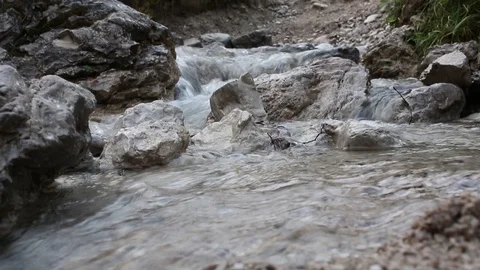 Small mountain stream, flowing over rocks in the alps Video stock 94507884