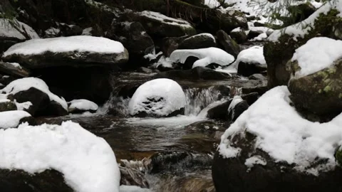 A small mountain stream in forest. Winter Mountain Stream. Mountain River.  A Video stock 166217546
