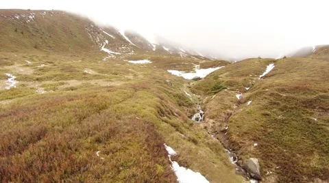 A Small Mountain Stream in Mountain Tundra in Mist Stock Footage 63961428
