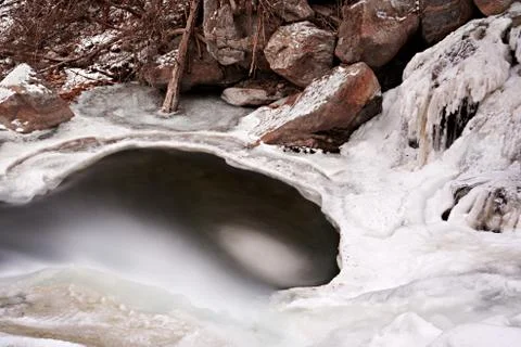 A small mountain stream in winter in Austria. Stock Photos