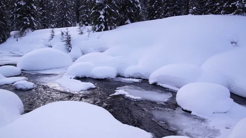A small mountain stream in winter forest. Beautiful snow drifts. Stock Footage 72895767