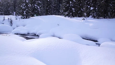 A small mountain stream in winter forest. Beautiful snow drifts. Stock Footage 72895771