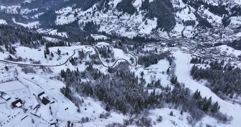 A small mountain town is covered in snow on a sunny winter day.Hunedoara Romania Video stock 205096545