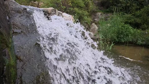 Small mountain waterfall flowing over rocky slope, Shandong, China, 21 Jan 2024 Stock Footage 345918186
