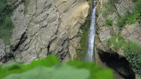 Small mountain waterfall in slow motion. Water slowly falls between the rocks Stock Footage 154222317
