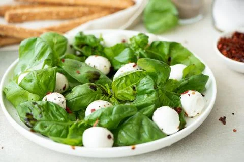 Small mozzarella balls with basil and balsamic vinegar Stock Photos