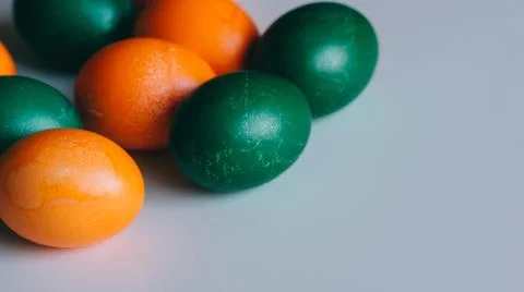 Small multi-colored Easter eggs on the kulich, festively decorated with color Stock Photos