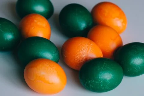 Small multi-colored Easter eggs on the kulich, festively decorated with color Stock Photos