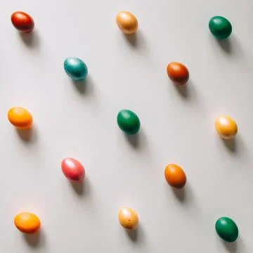 Small multi-colored Easter eggs on the kulich, festively decorated with color Stock Photos