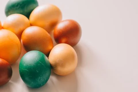 Small multi-colored Easter eggs on the kulich, festively decorated with color Stock Photos
