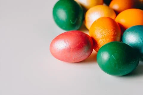 Small multi-colored Easter eggs on the kulich, festively decorated with color Stock Photos