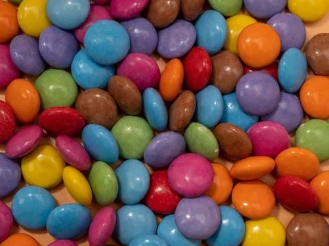 Small multi-colored round candies. Sweets covered with sugar icing. Stock Photos