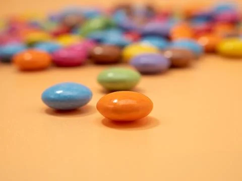 Small multi-colored round candies. Sweets covered with sugar icing. Stock Photos
