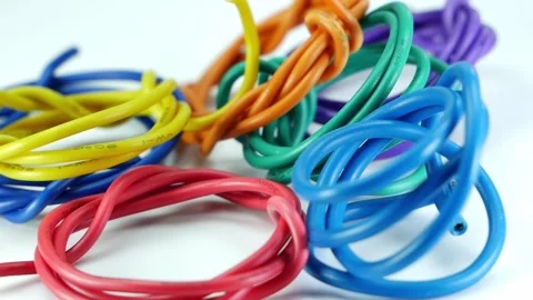 Small multi-colored wires, slowly rotating on a white background. Stock Footage 261428733