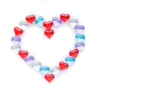 Small multicolored hearts lie in the shape of a large heart Stock Photos