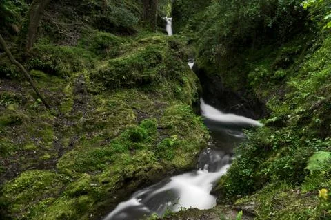 Small narrow waterfall in magic forest Stock Photos