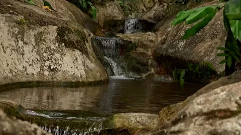 Small Natural Waterfall Flowing Over Rocks Stock Footage 329301632
