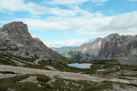Small, navy blue lakes at the bottom of the valley in Italian Alps Stock Photos