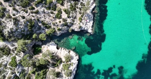 Small notch in the cliffs at the Calanque national park with people swimming Video stock 247666428