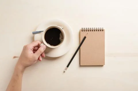 Small notebook and coffee cup Stock Photos