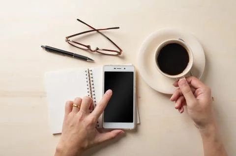 Small notebook and coffee cup Stock Photos