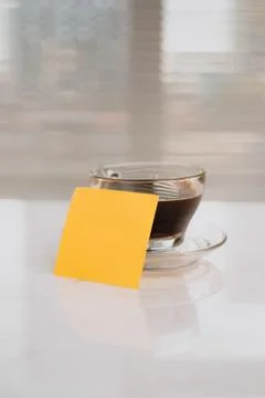 Small notebook with blank area for text or message on brown cover and coffee Stock Photos