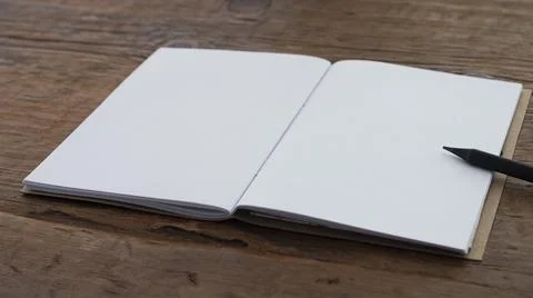 Small notebook with blank pages on an old brown wood Stock Photos