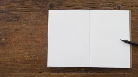 Small notebook with blank pages on an old brown wood Stock Photos