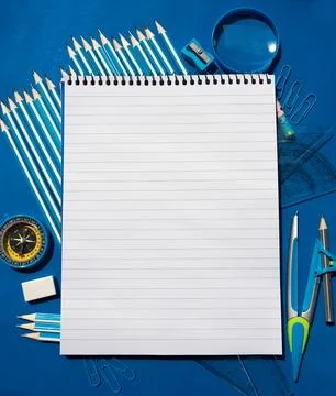 Small notebook on blue background Stock Photos