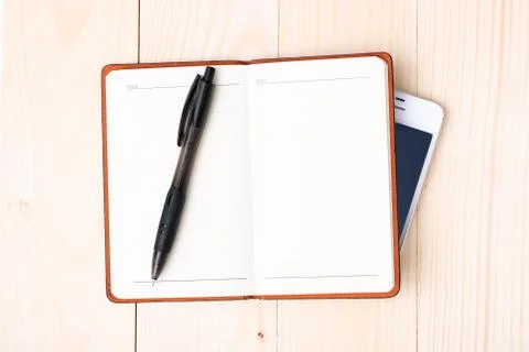 Small notepad with pen and smartphone Stock Photos