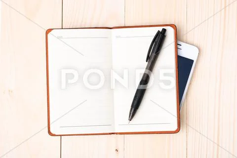 Small notepad with pen and smartphone Stock Photos