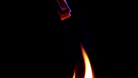 Small Object Engulfed In Bright Orange Flames Held By Red Clip On Black Stock Footage 330301181