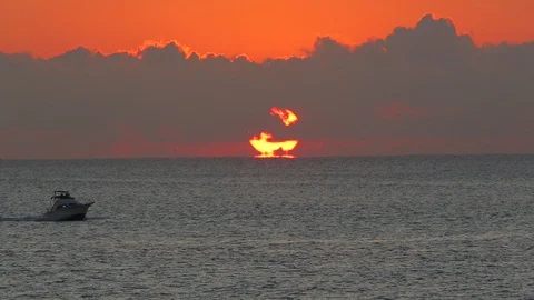 Small ocean motorboat going across horizon in the morning A Stock Footage 107280652