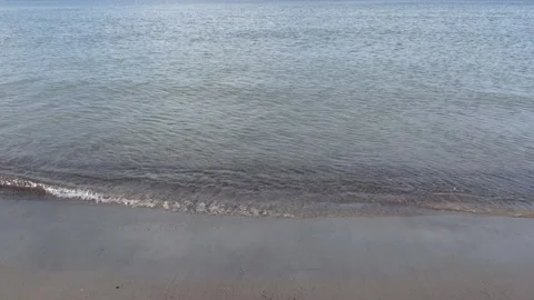 Small ocean waves on the beach shore seen from close - maritime background Stock Footage 143496332