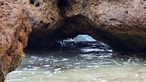 Small ocean waves crashing through a cave in Oahu Hawaii Stock Footage 279909854