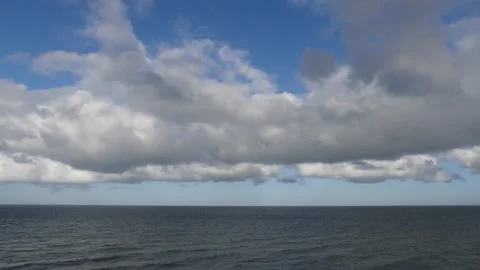 Small ocean waves with horizon - beautiful blue cloudy sky - maritime background Stock Footage 143590425