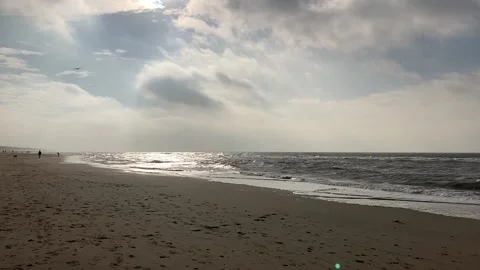 Small ocean waves at the long beach in nice atmosphere and blue sky Video stock 143811557