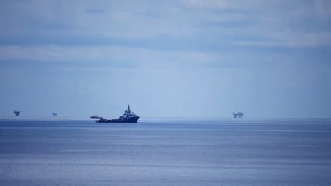 Small offshore platform and crew boat in the middle of the ocean Stock Footage 76851343