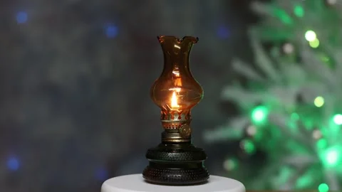 A small oil lamp stands on the table Stock Footage 295812093