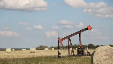 Small Oilwell Pump Jack in a Field Stock Footage 89237768