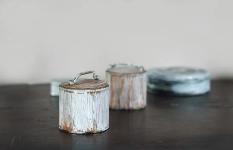 Small old boxes painted white on the wooden table Stock Photos